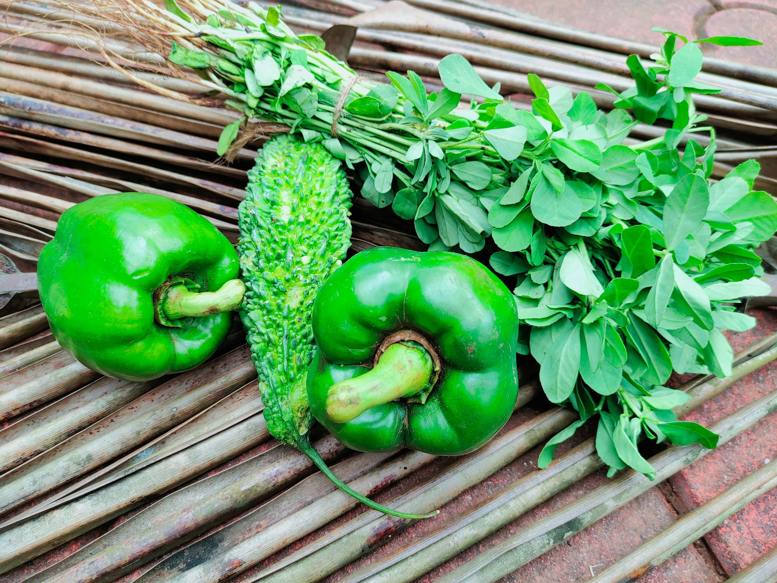 Fresh green organic vegetables on a wooden background
