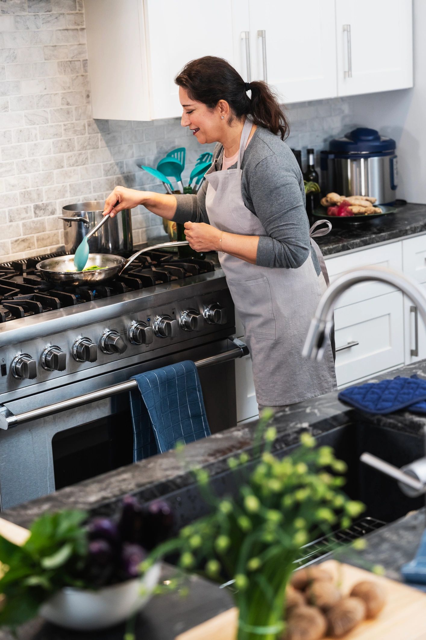 Woman cooking homemade Indian food in a kitchen